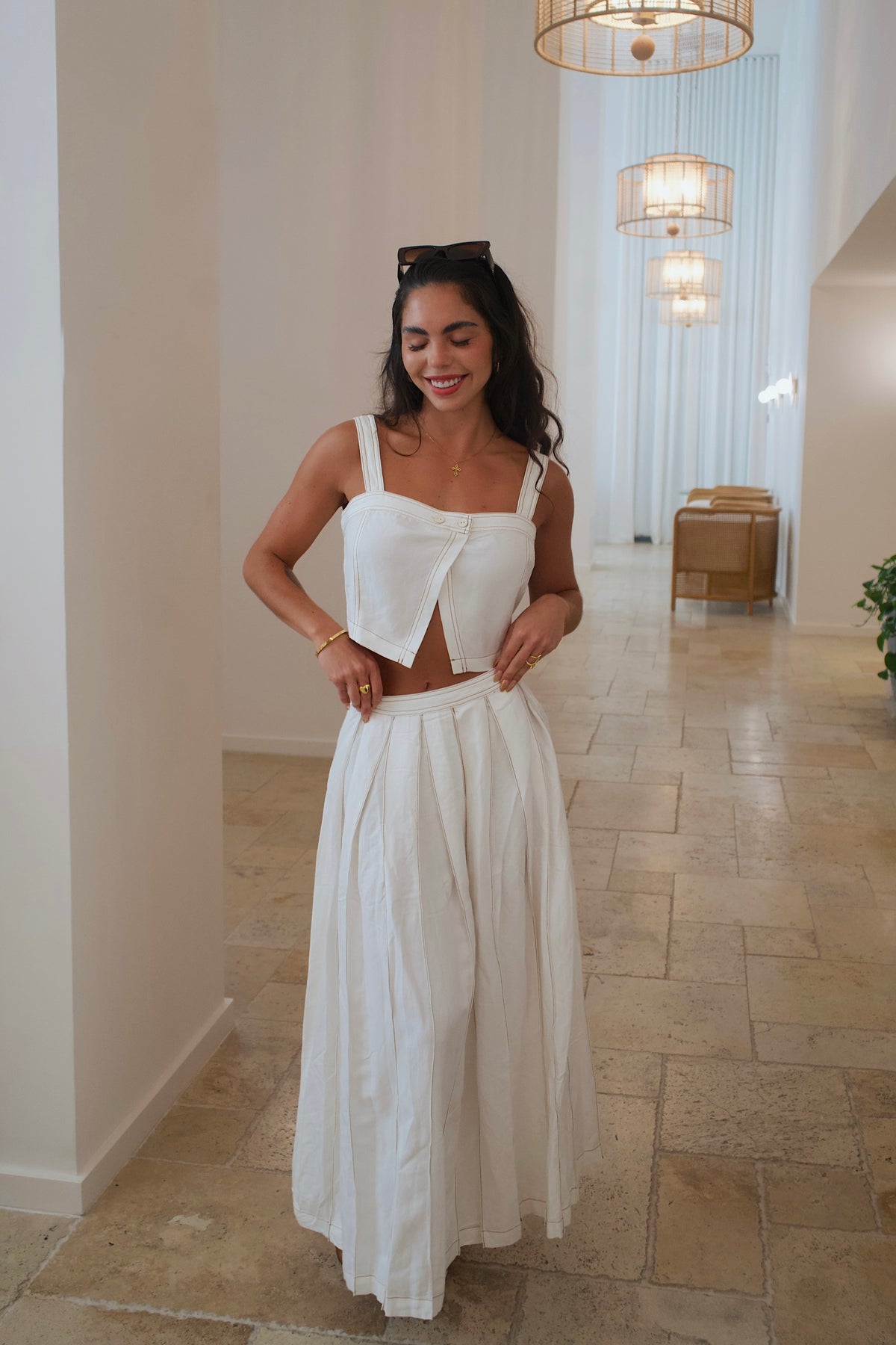 Chic linen outfit featuring a cropped top and matching skirt with modern details