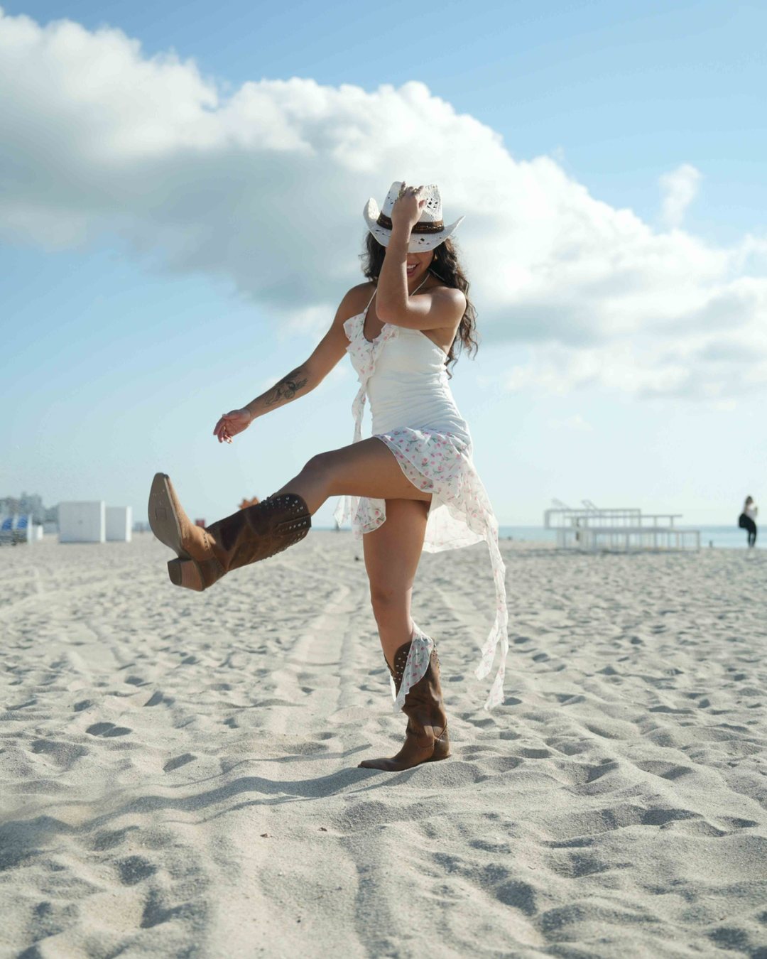 Coastal cowgirl-inspired mini dress with soft ruffles and tie accents for beach dates and festivals