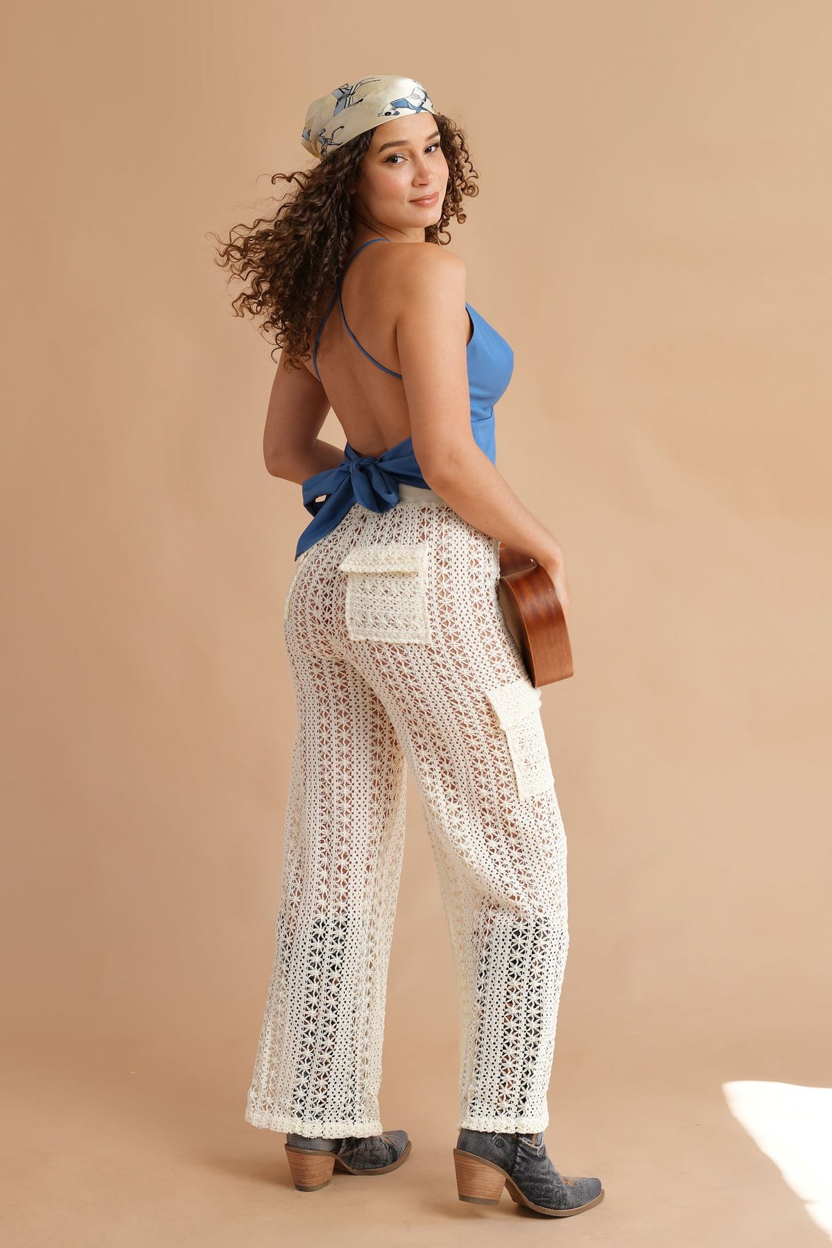 Flared crochet pants featuring elastic waistband and decorative cord tie at the waist