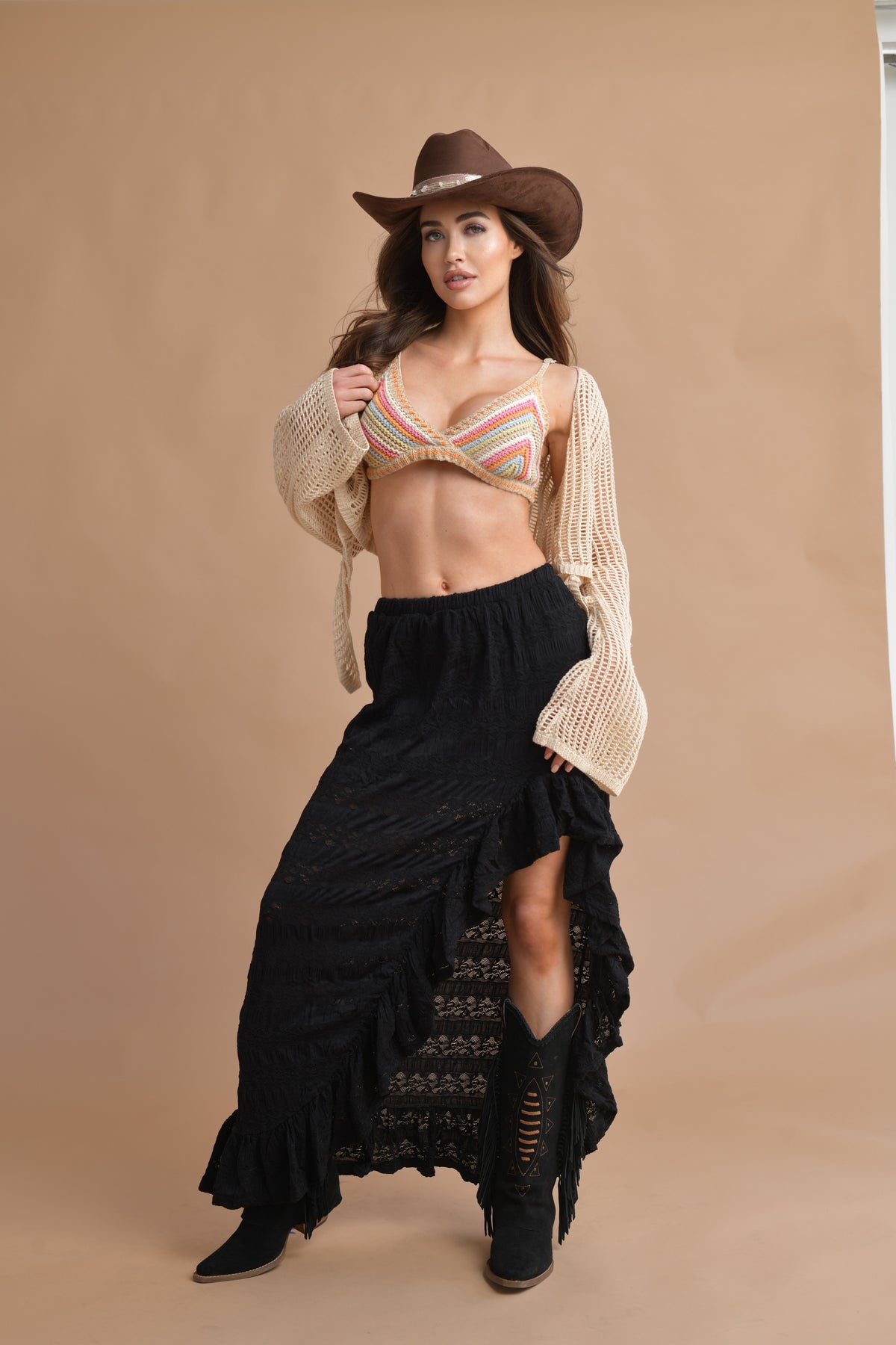 Trendy festival outfit featuring a lightweight crochet cowgirl shirt and black skirt