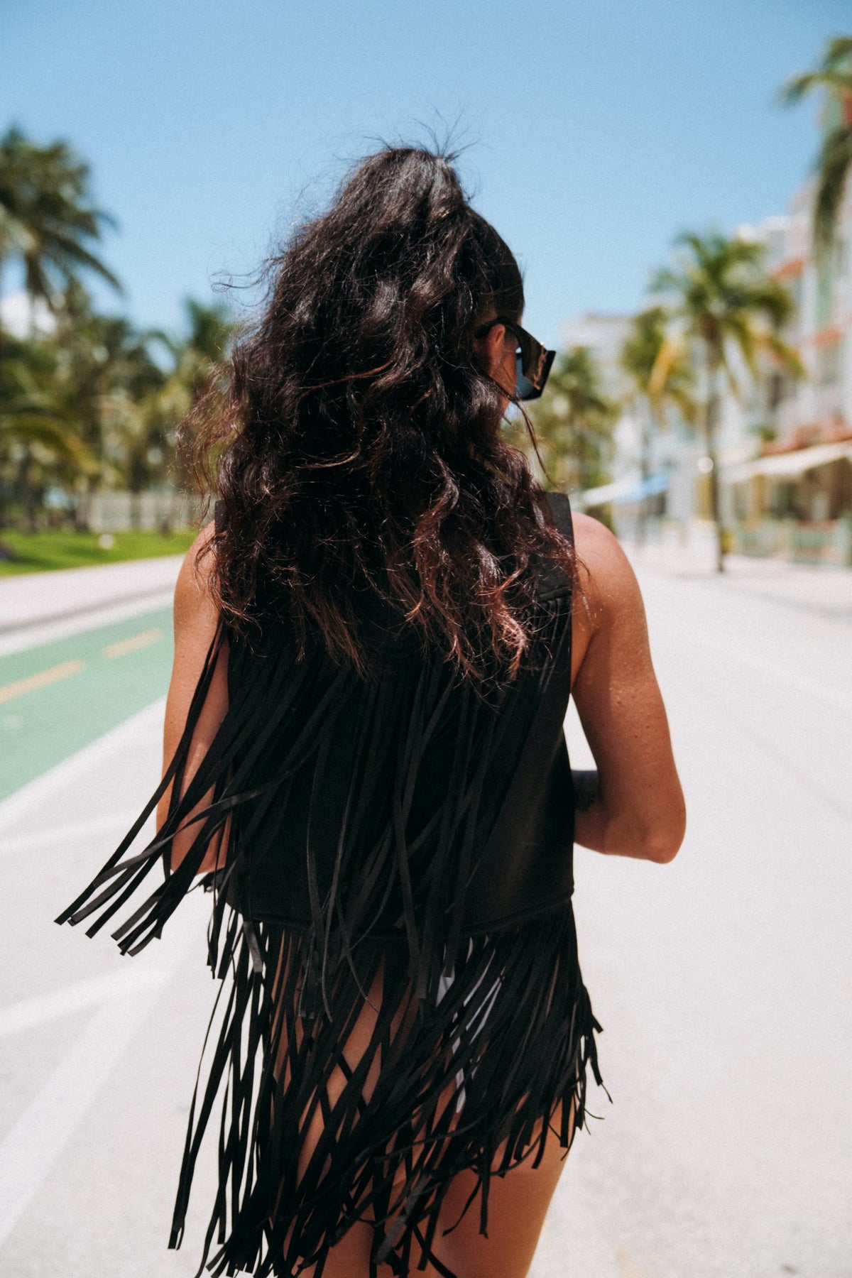 Festival-ready fringe vest in black vegan fabric, adds western flair to your summer outfits