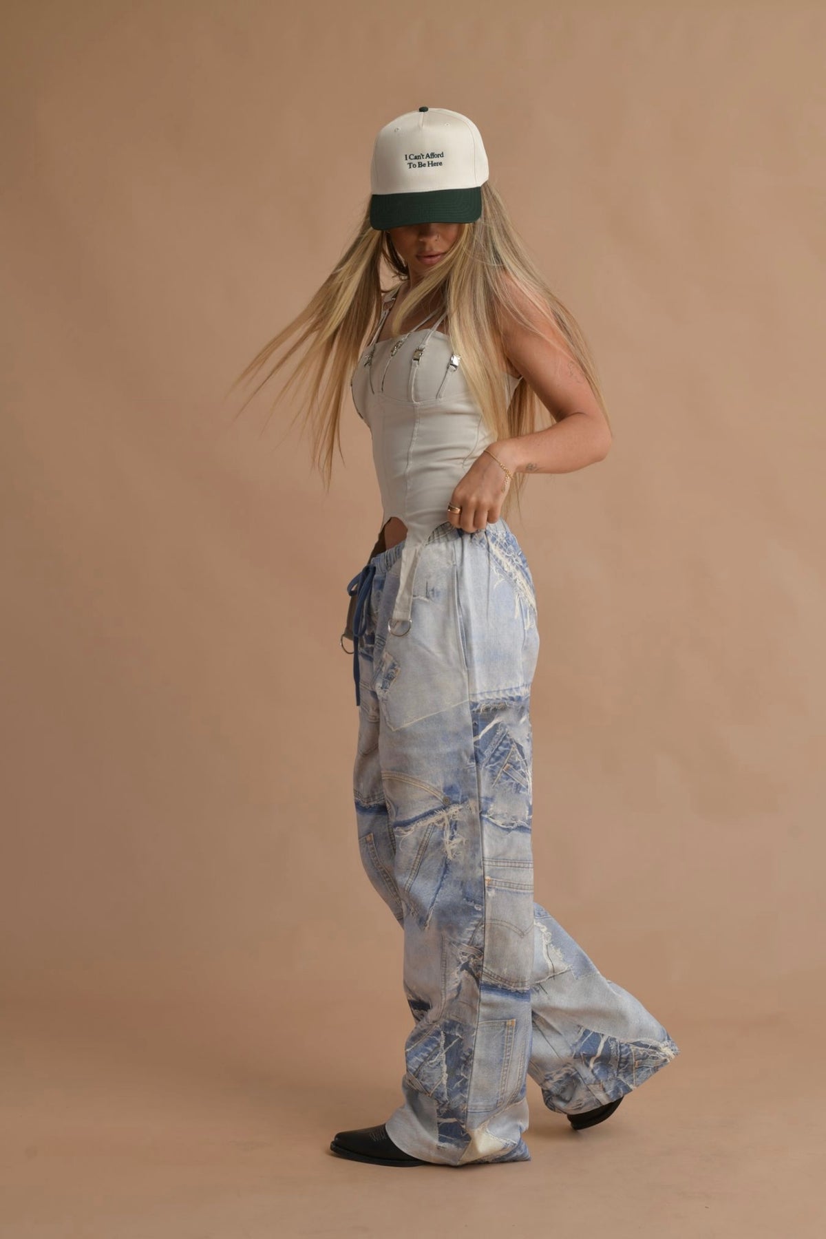 Street-style inspired women’s buckle top paired with printed denim cargo pants.