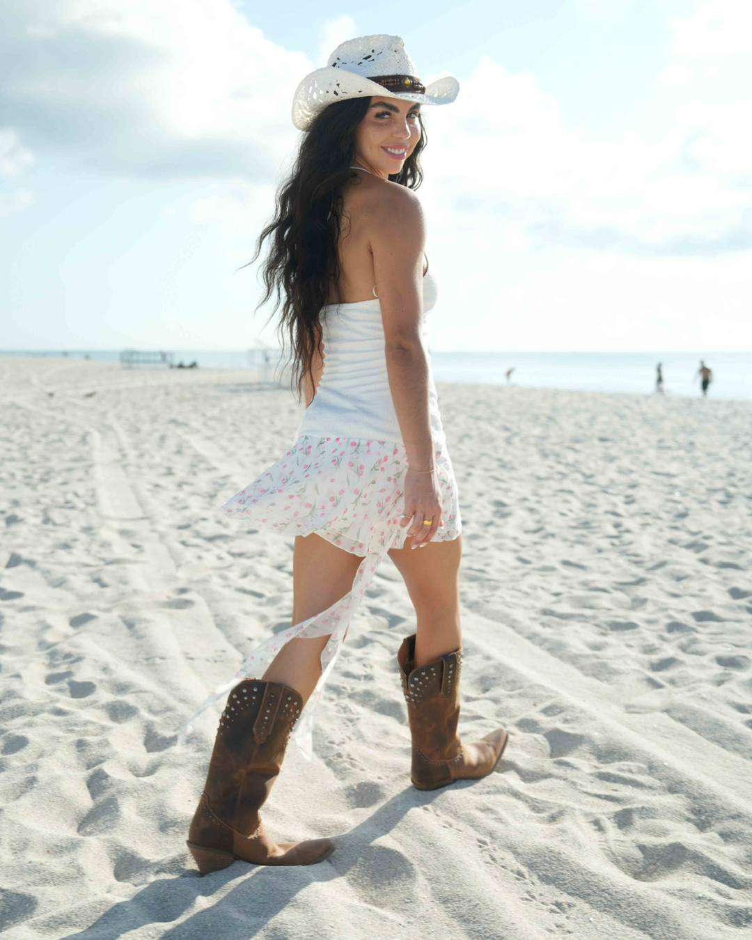 Flowy halter mini dress with asymmetrical ruffles and a vibrant rose print