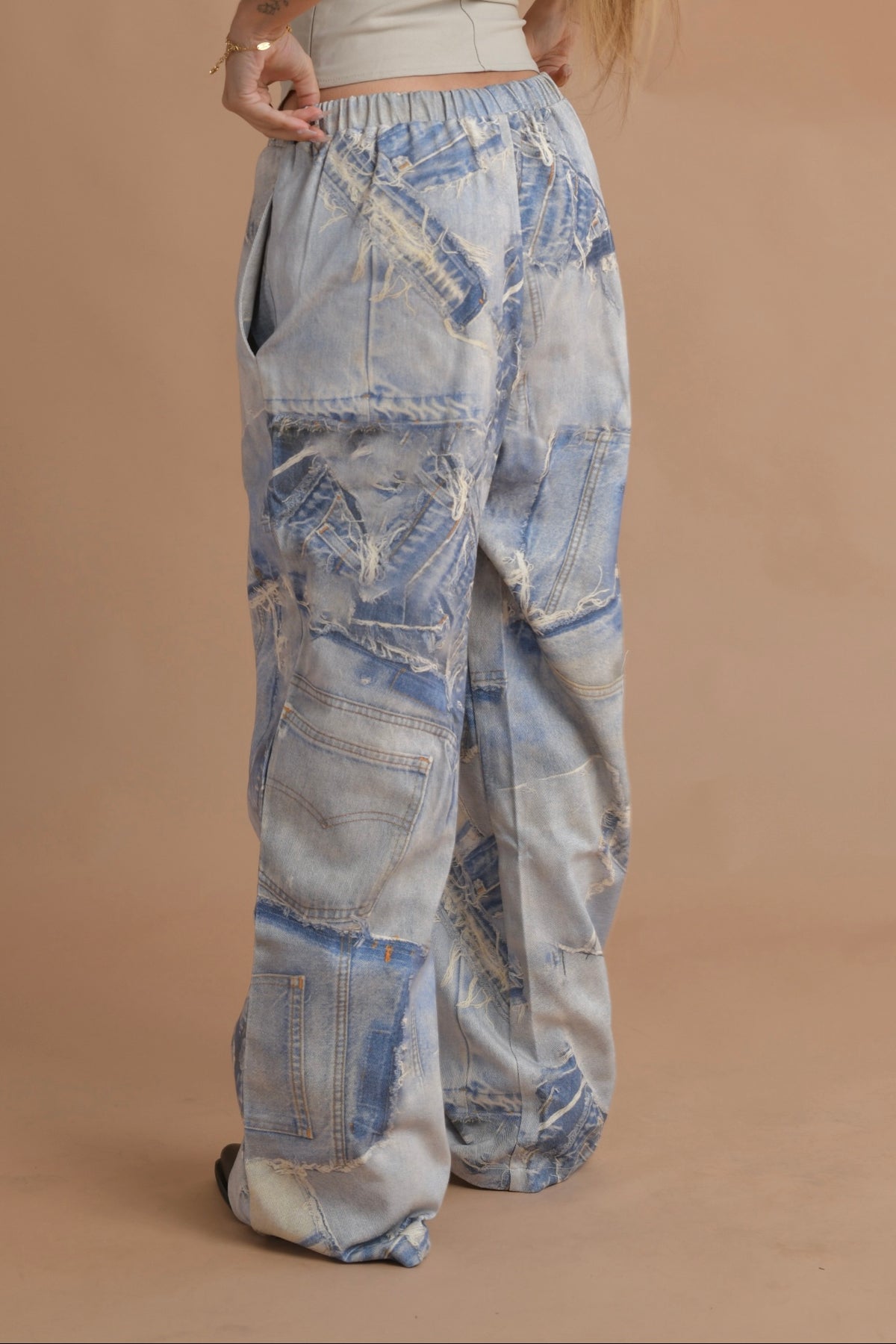 Printed blue denim cargo pants paired with black boots for a modern street-style look.