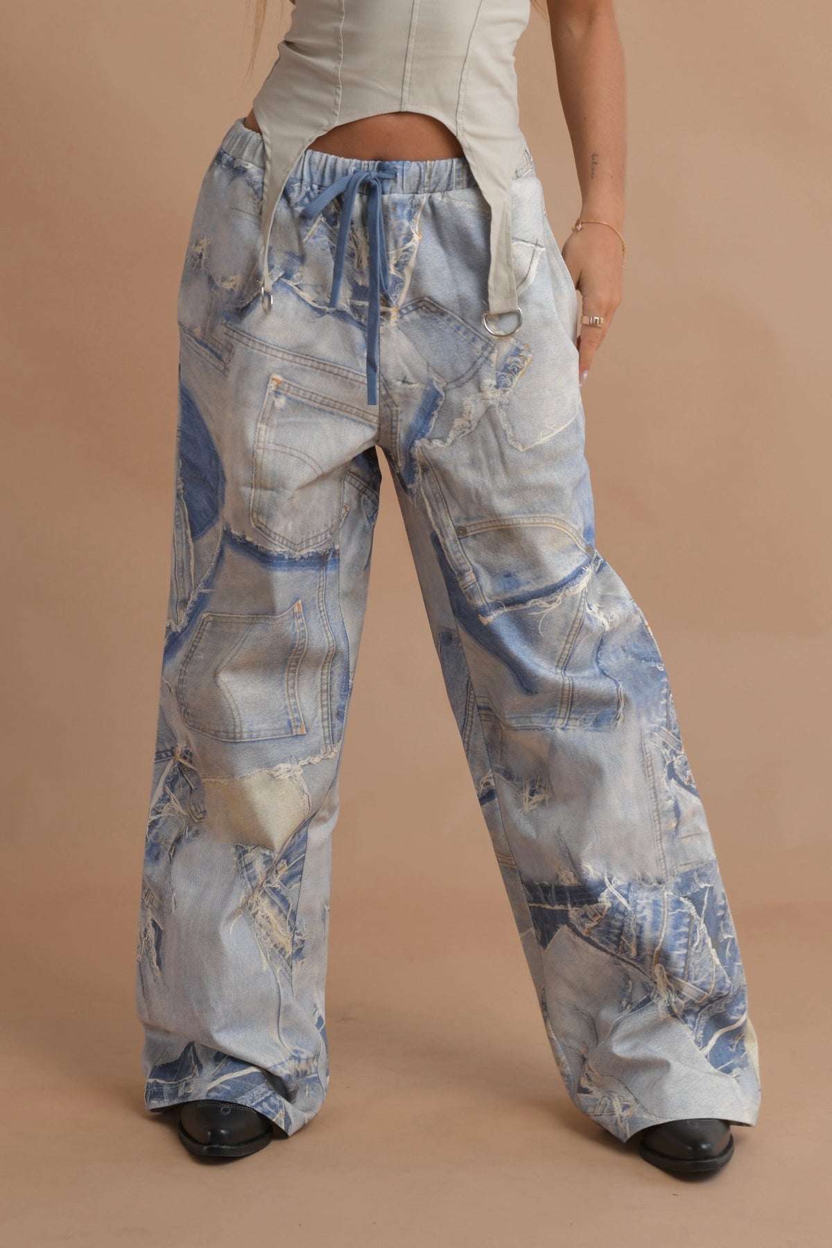 High-waisted loose-fit cargo jeans with utility pockets and a trendy distressed design.