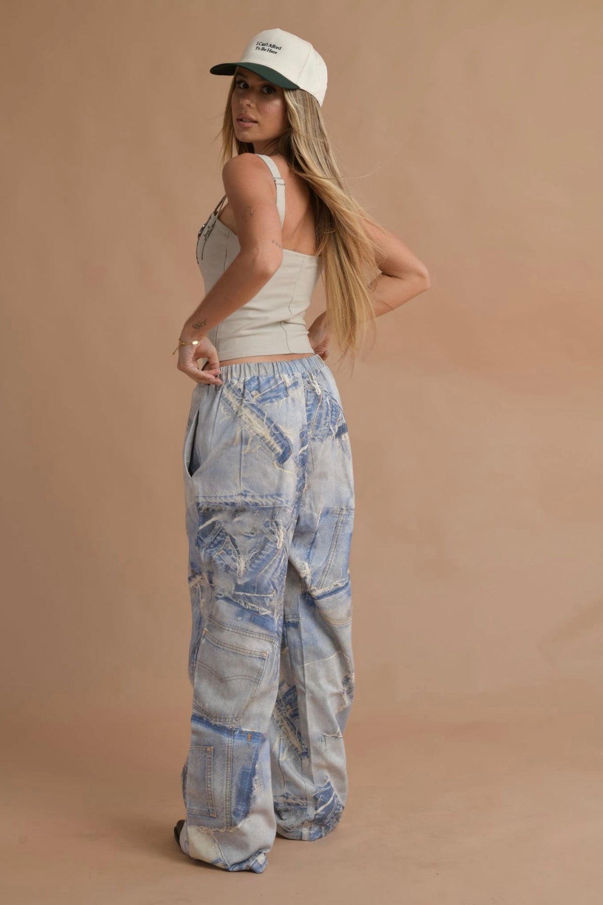 Trendy festival outfit featuring a strappy corset top with silver buckle details.