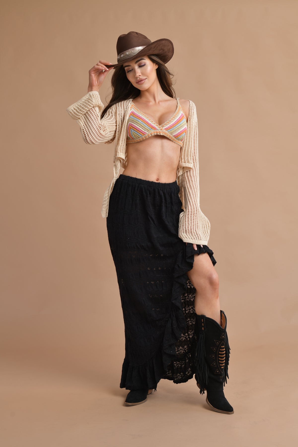 Boho-inspired open-knit crochet top with a stylish front tie and flared sleeves