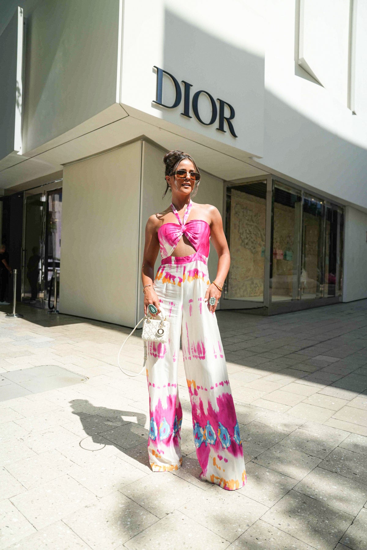 Tie dye jumpsuit styled for beach days, festivals, and rooftop parties
