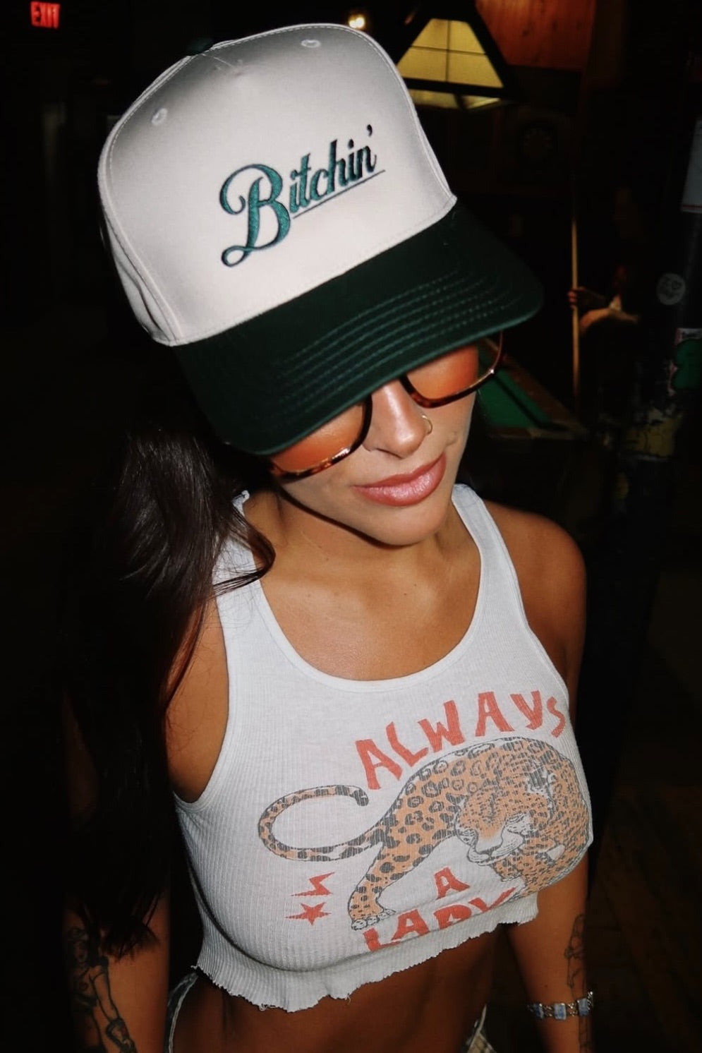 Model wearing bold embroidered mesh hat with vintage energy
