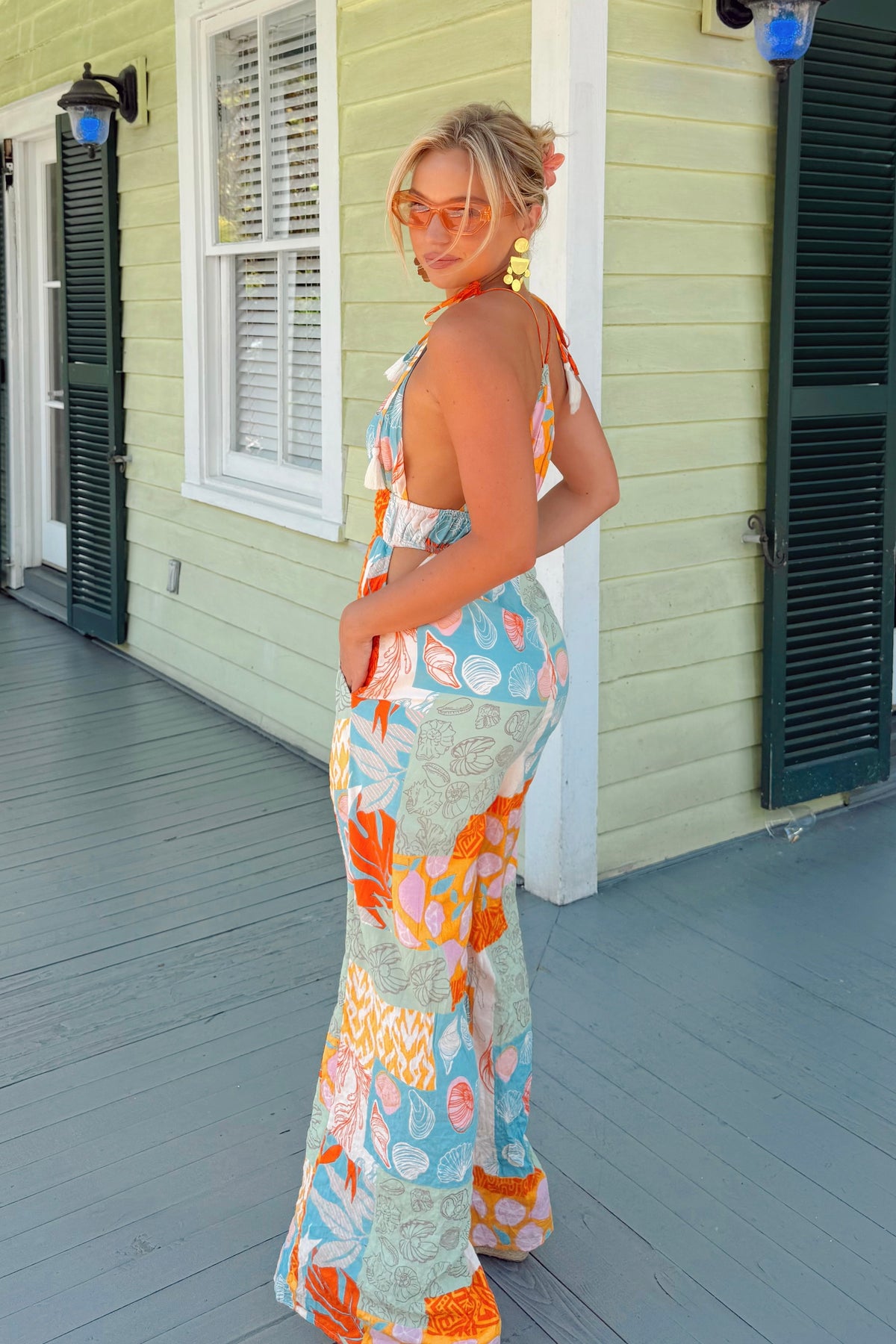 Tropical jumpsuit featuring flirty cut-out sides and breezy wide legs
