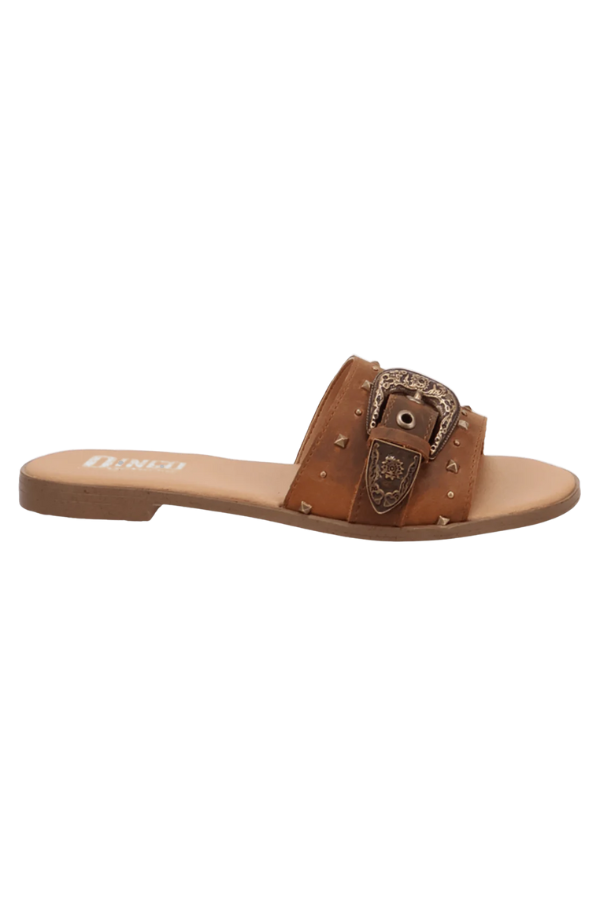 Party-ready sandal with bold western accessories and statement charm
